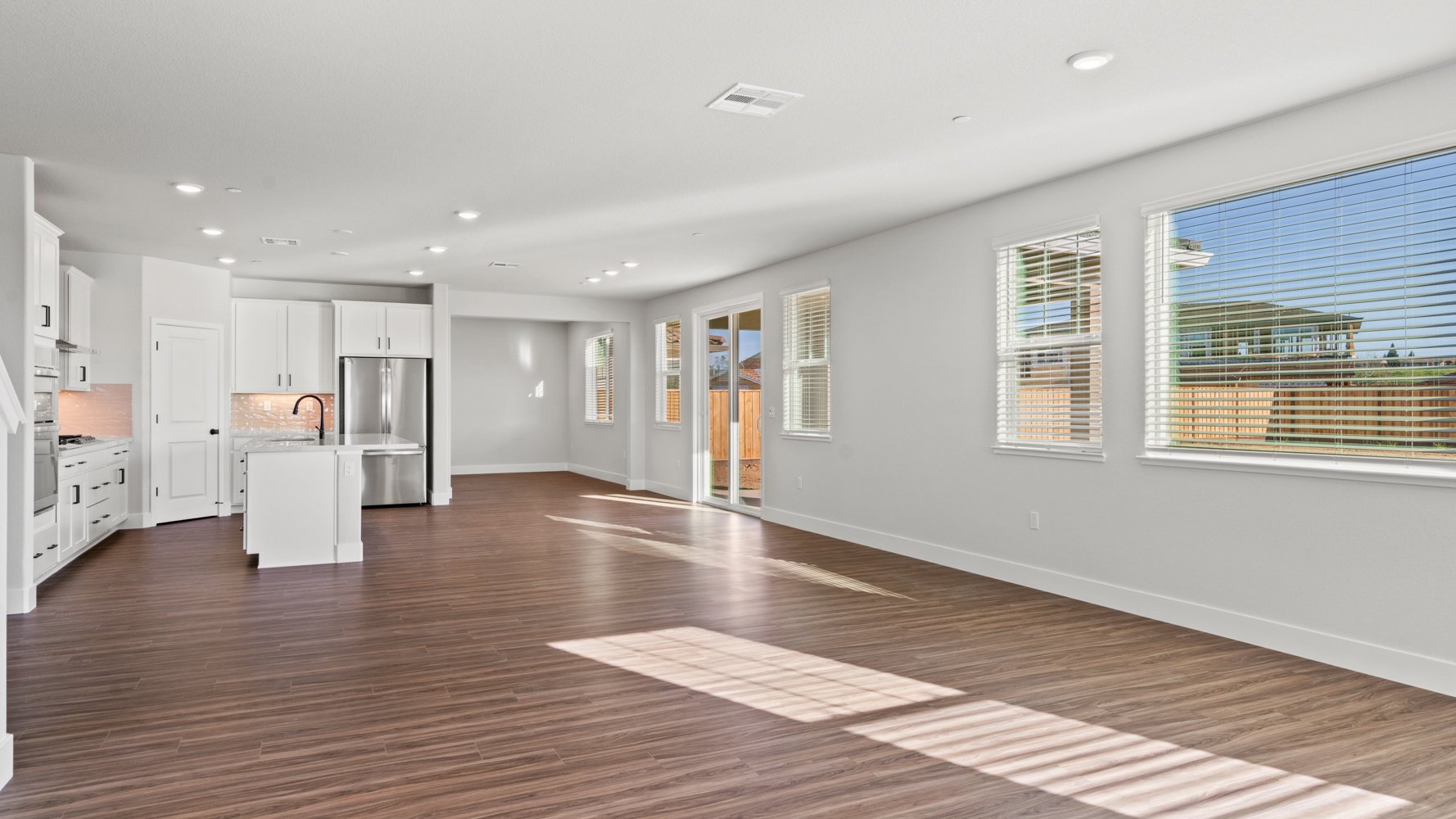 A large kitchen with white walls.