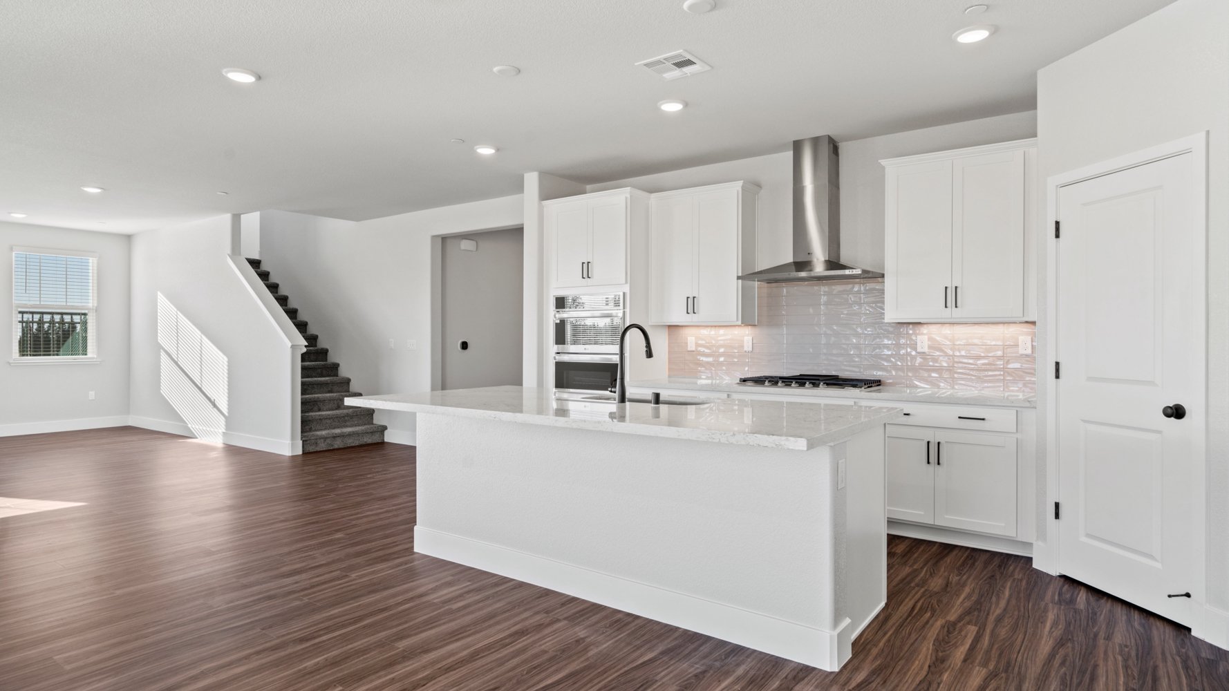 A kitchen with white cabinets.