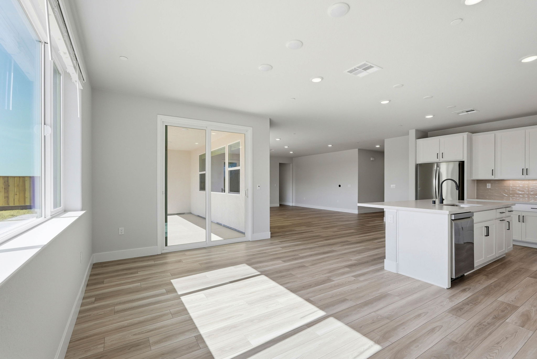 A large kitchen with white cabinets.