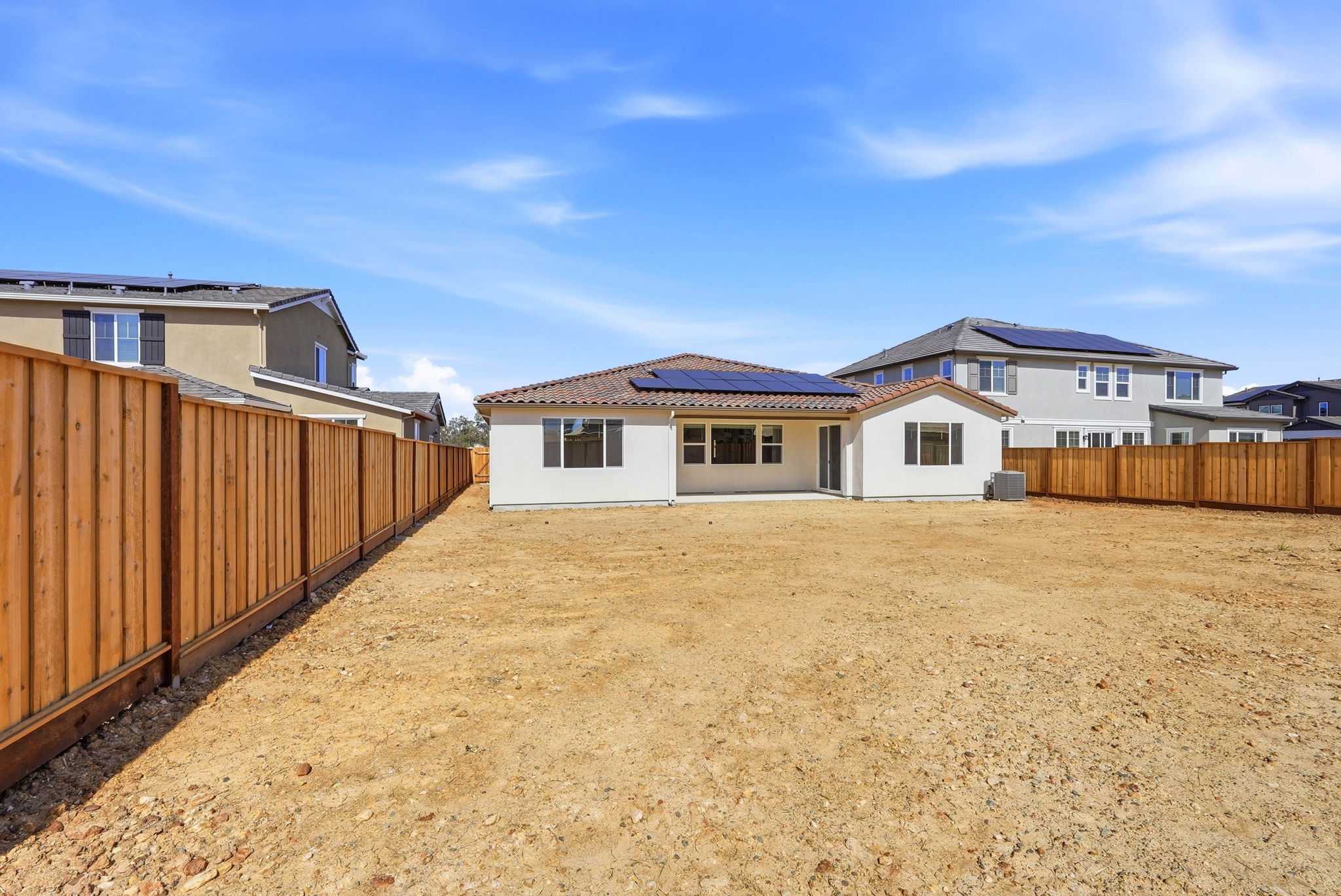 A dirt road with houses on either side of it.