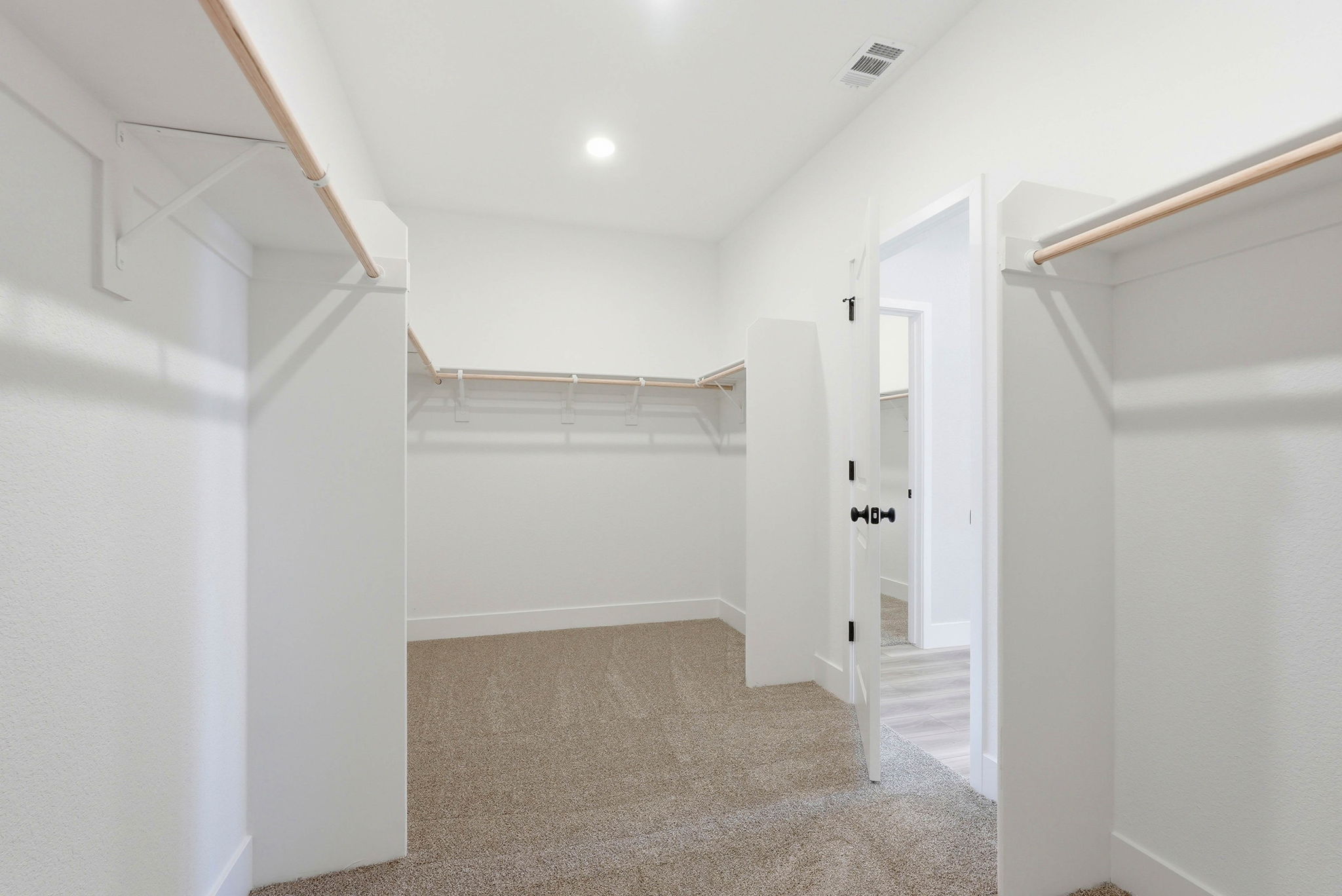 A hallway with white walls.