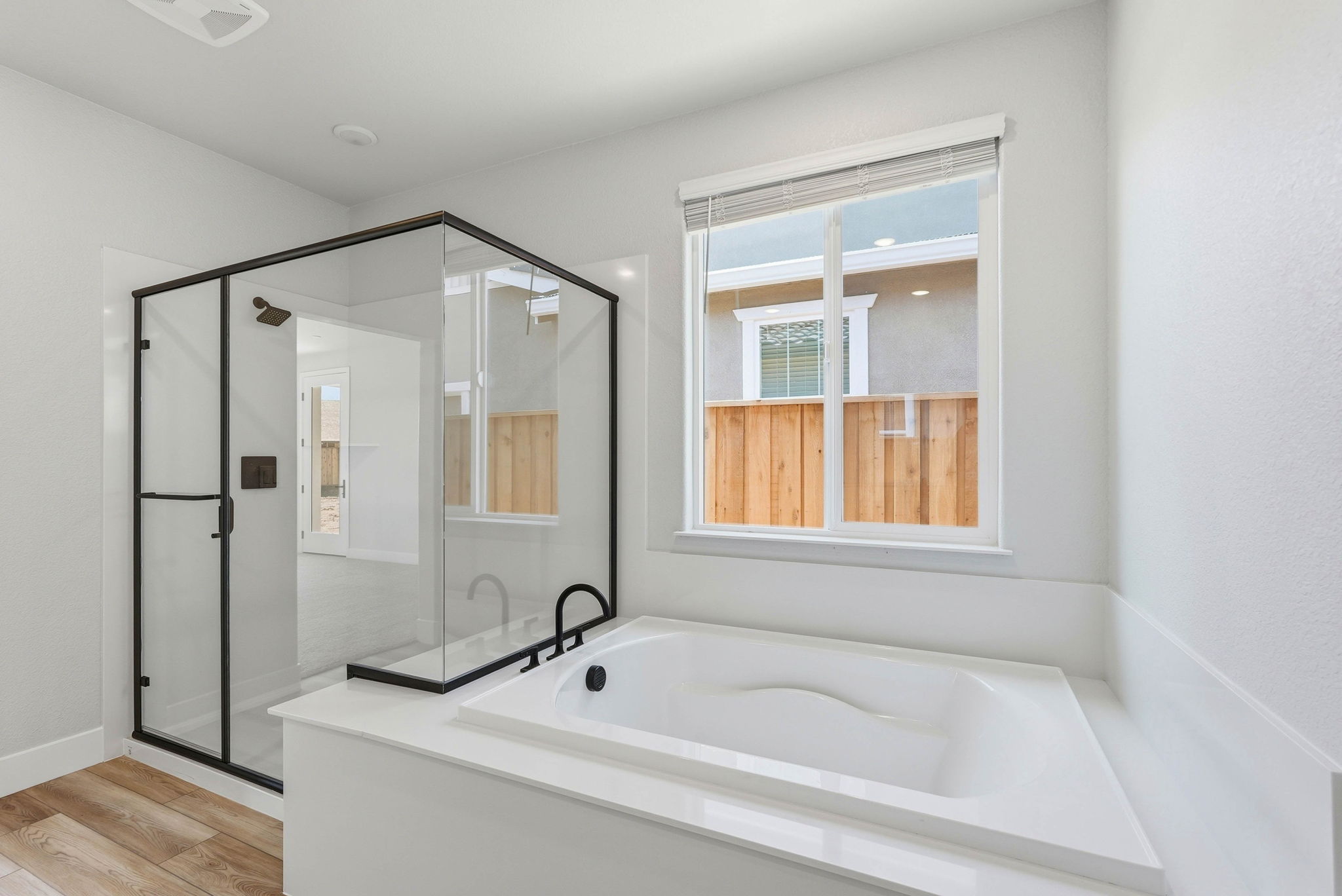 A bathroom with a tub and a window.