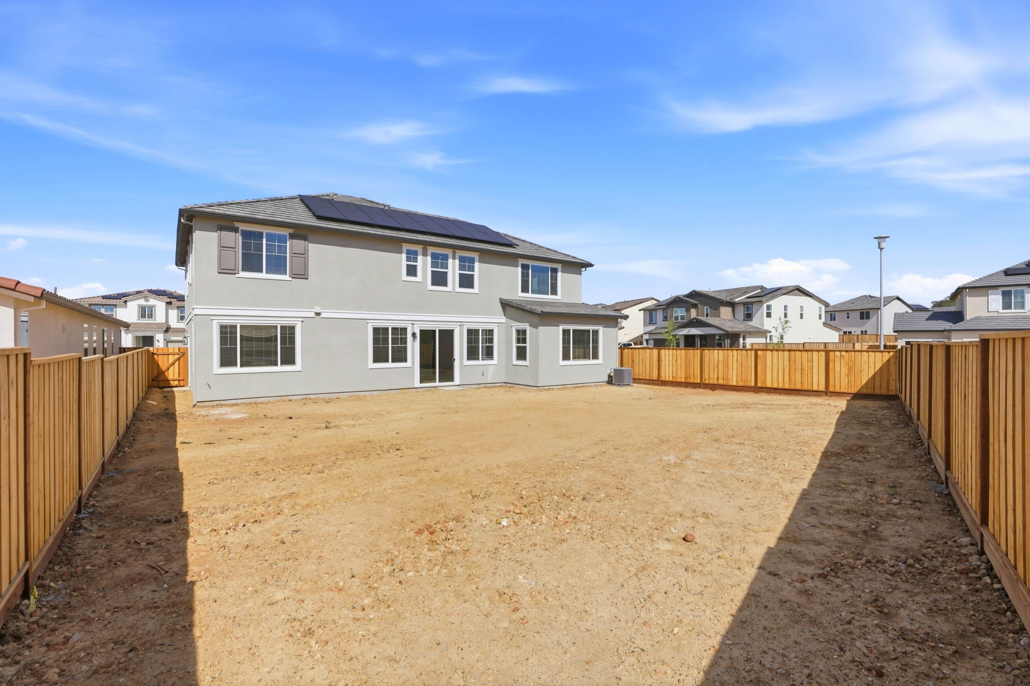 A dirt road with houses on either side of it.