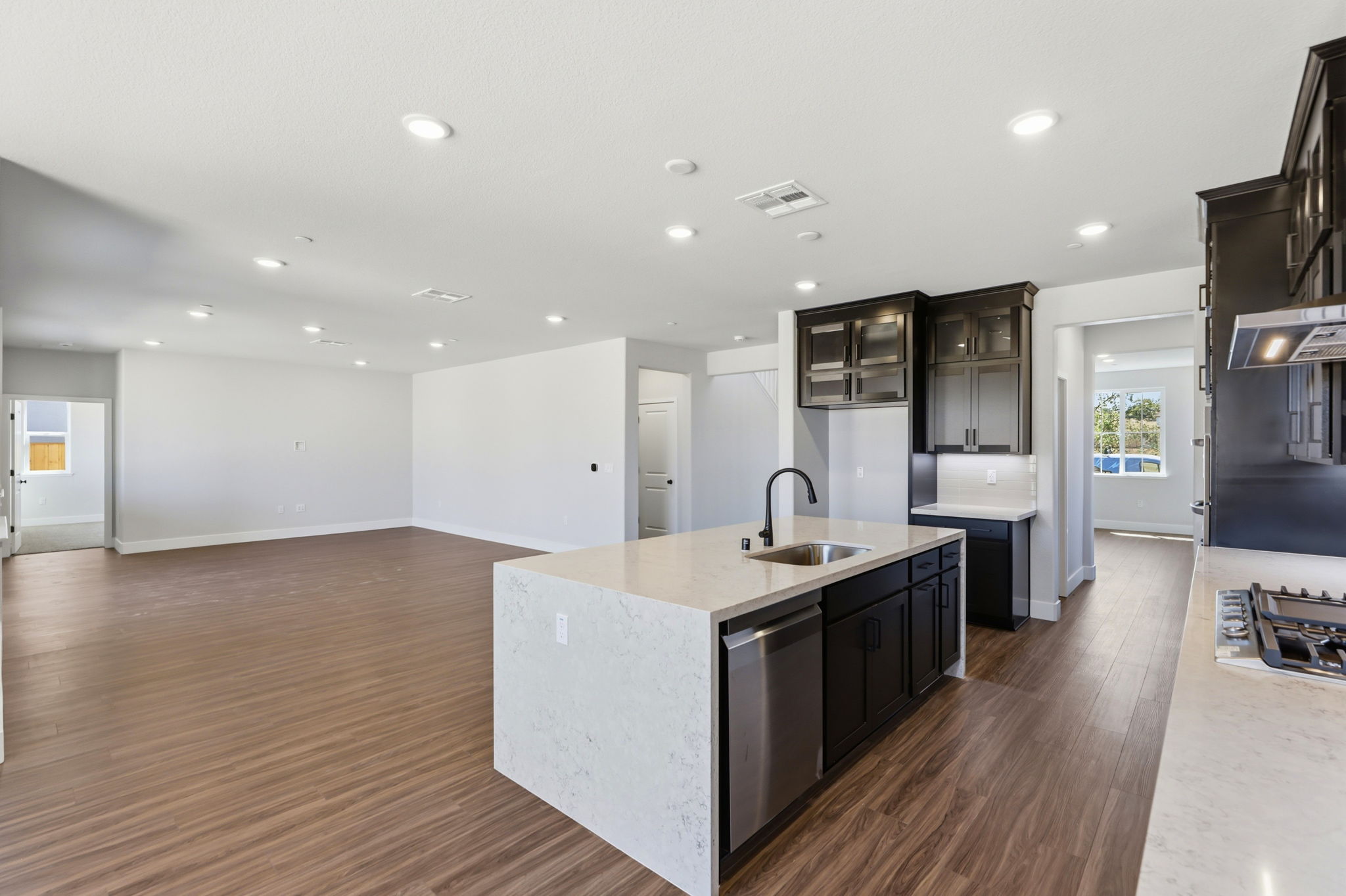 A kitchen with a wood floor.