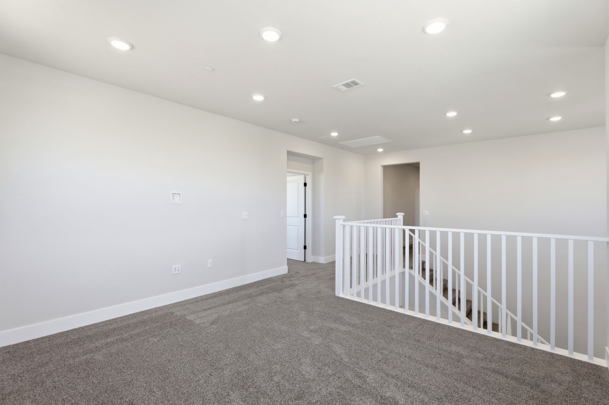 A white room with a railing.