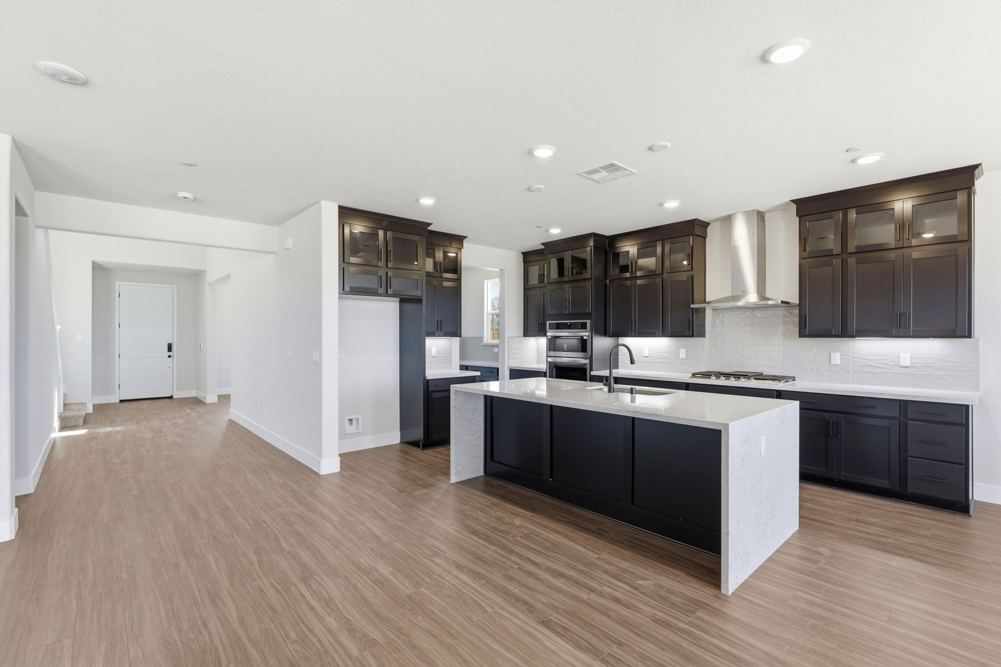 A kitchen with black cabinets.