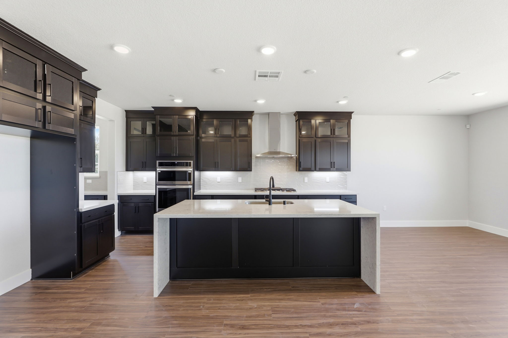 A kitchen with black cabinets.