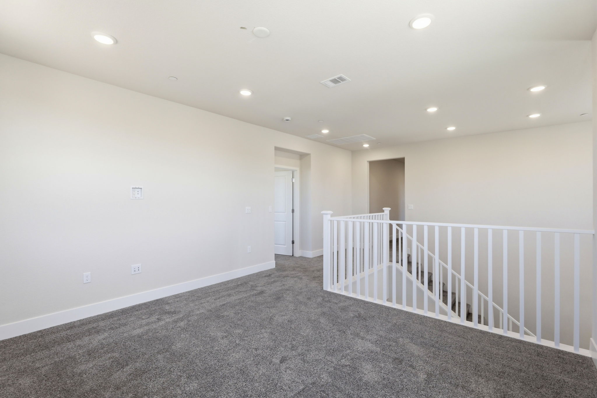 A white room with a railing.