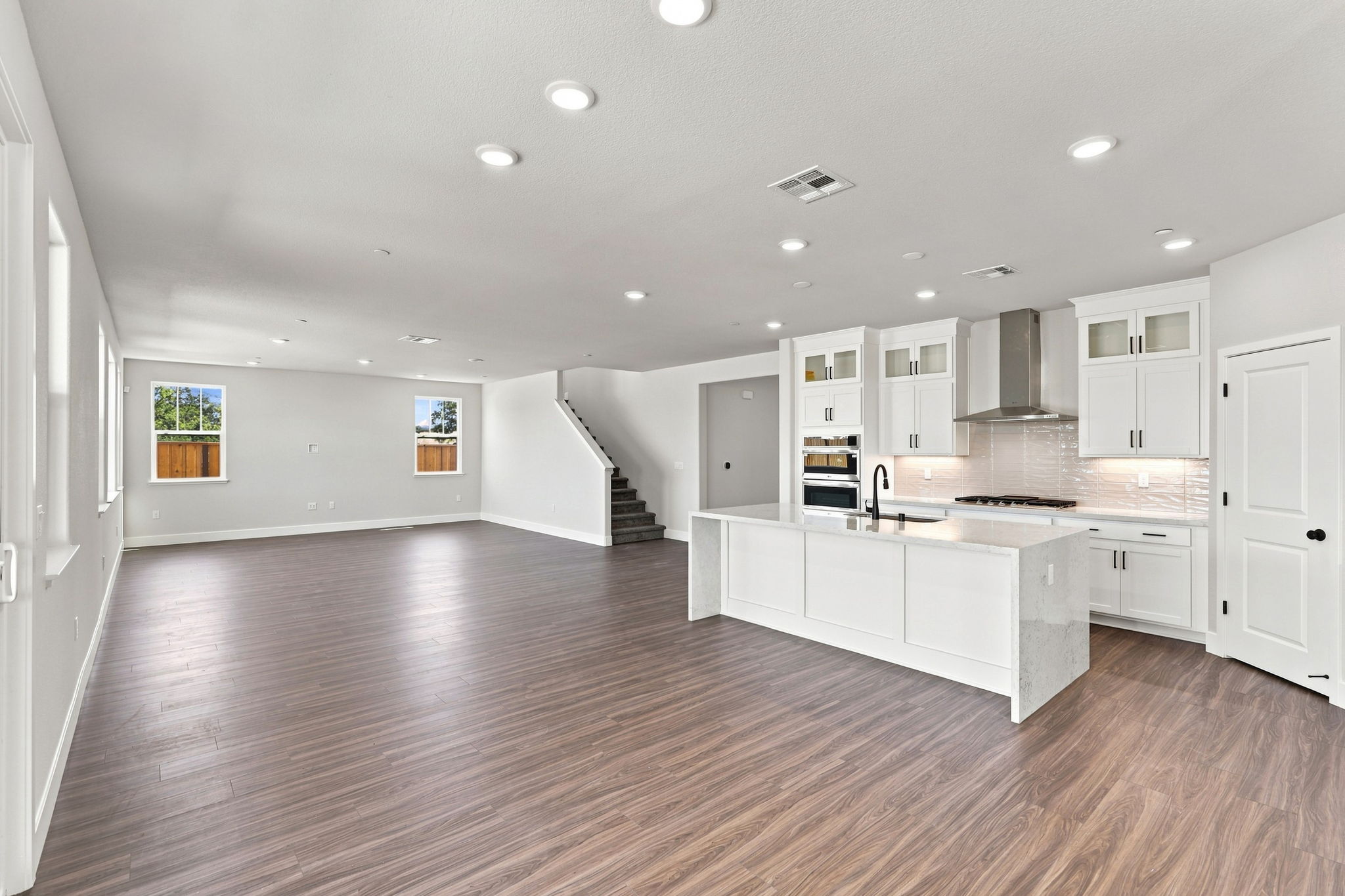A large kitchen with white cabinets.