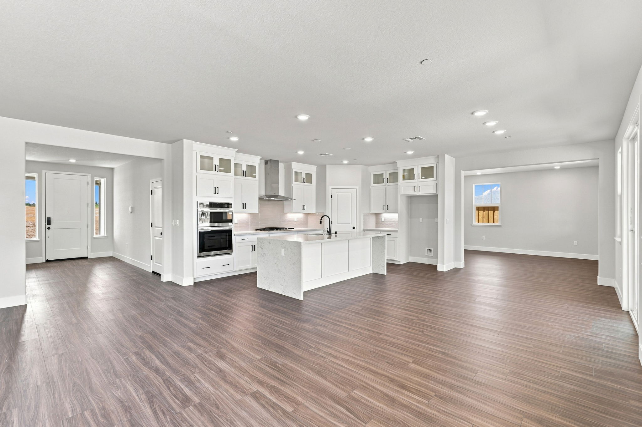 A large kitchen with white cabinets.