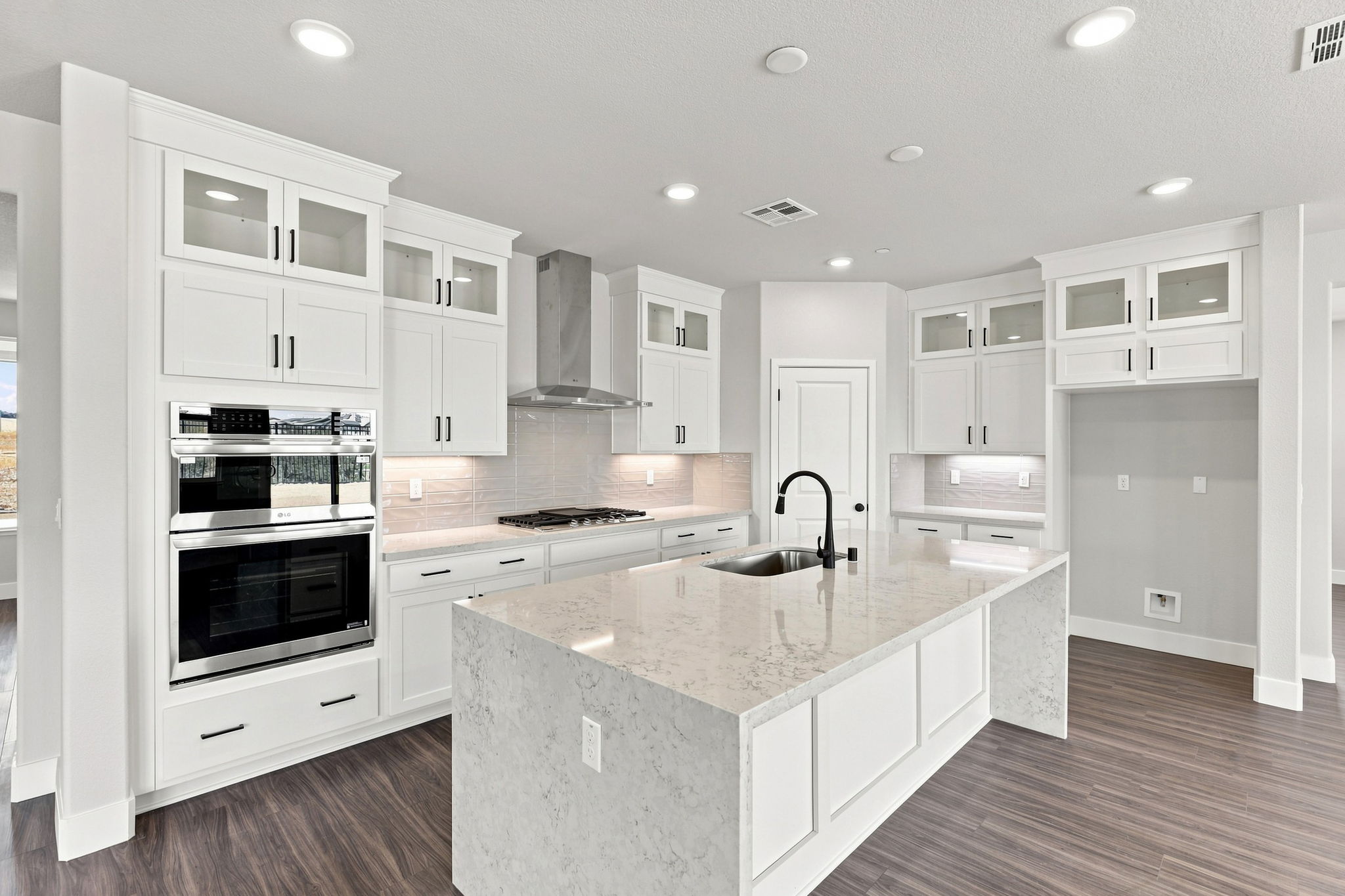 A kitchen with white cabinets.