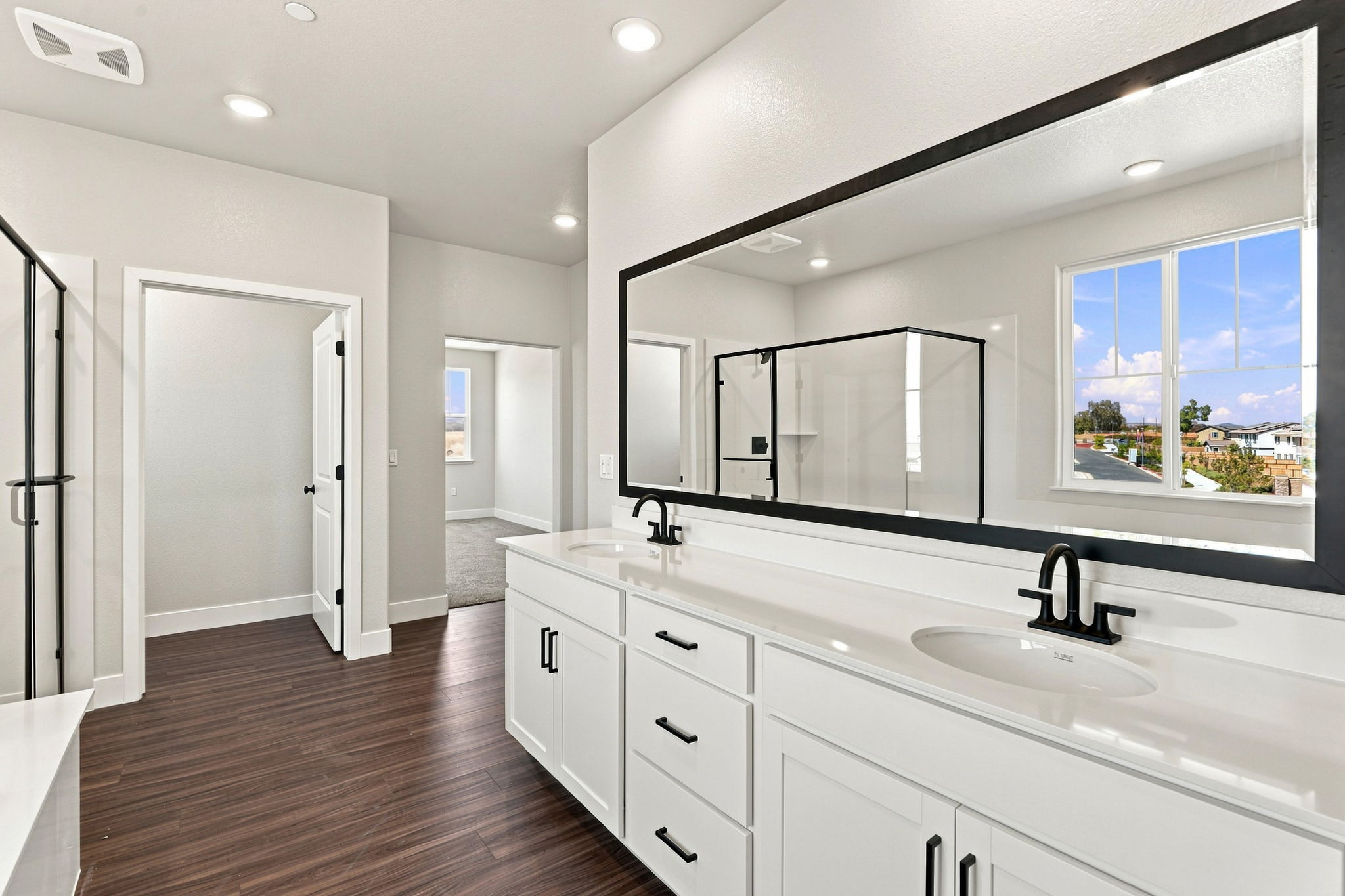 A bathroom with a large mirror.