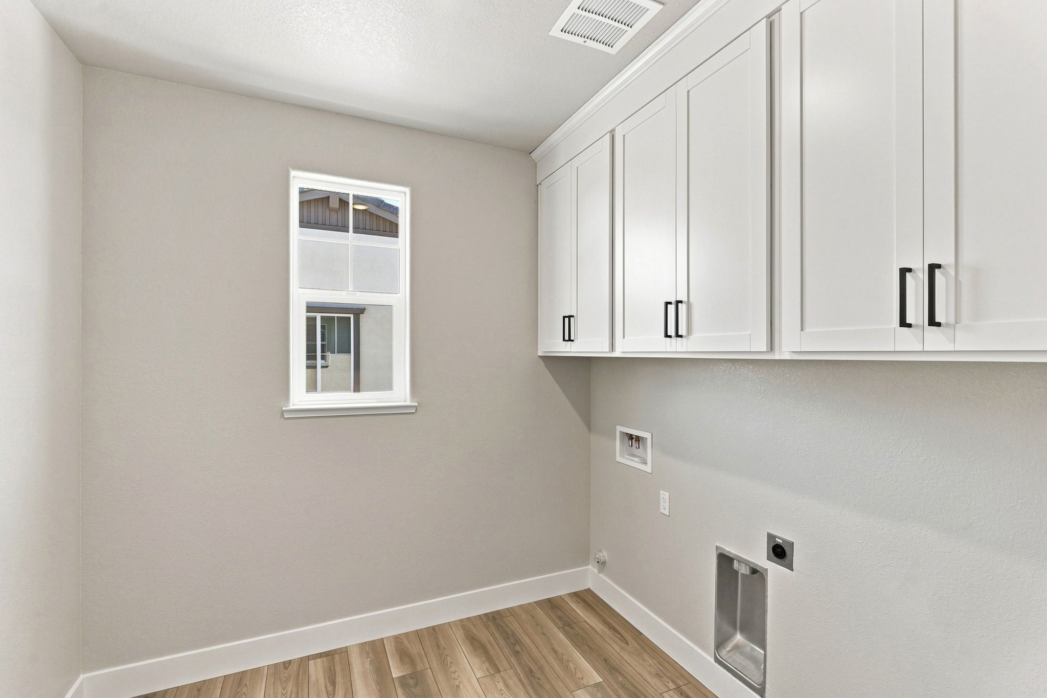 A white kitchen with white cabinets.