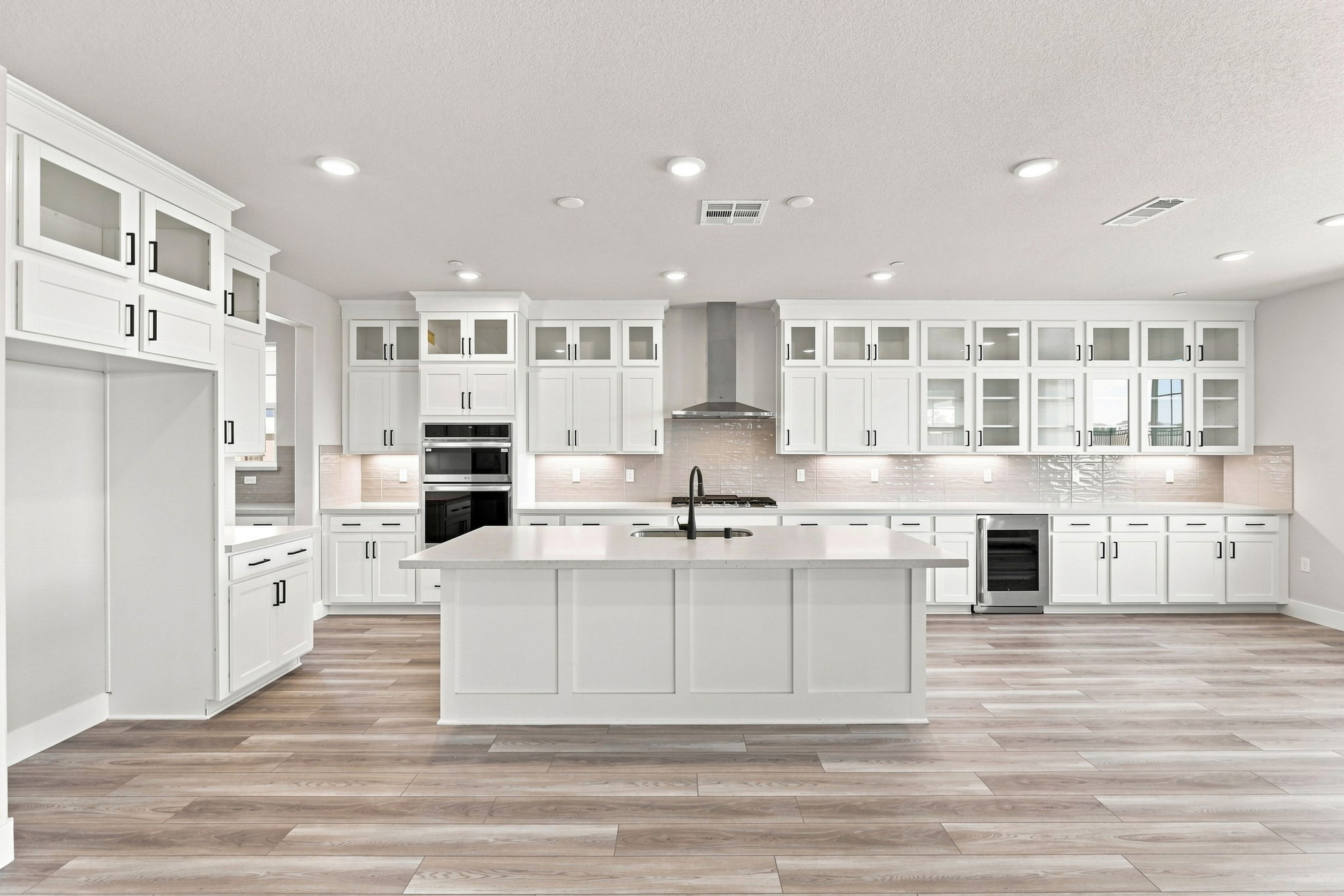 A kitchen with white cabinets.