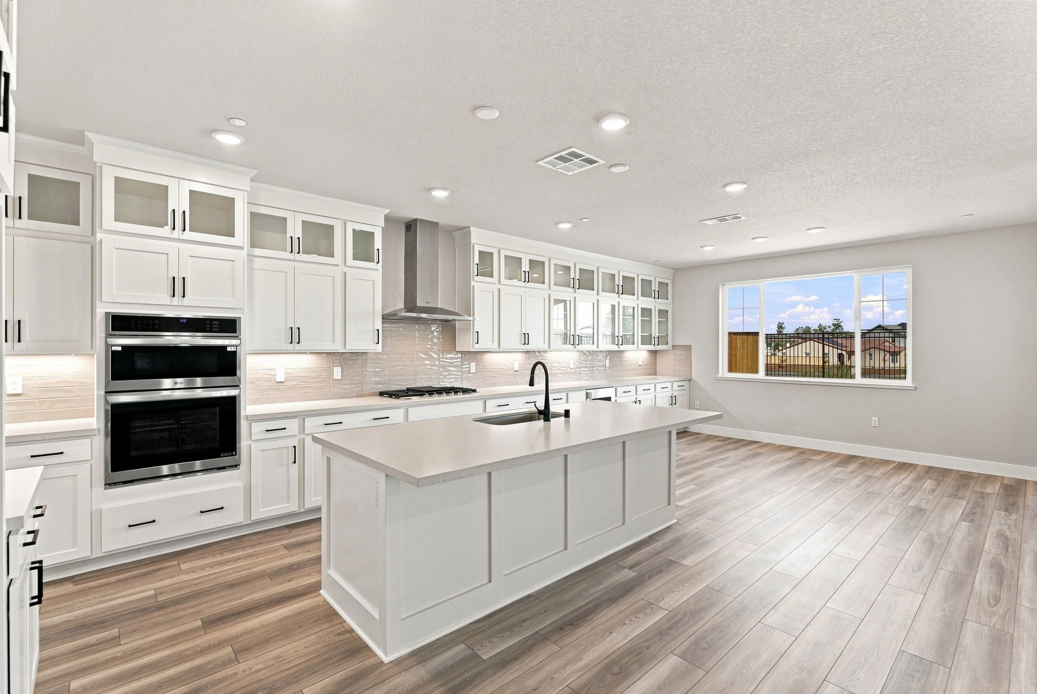 A kitchen with white cabinets.