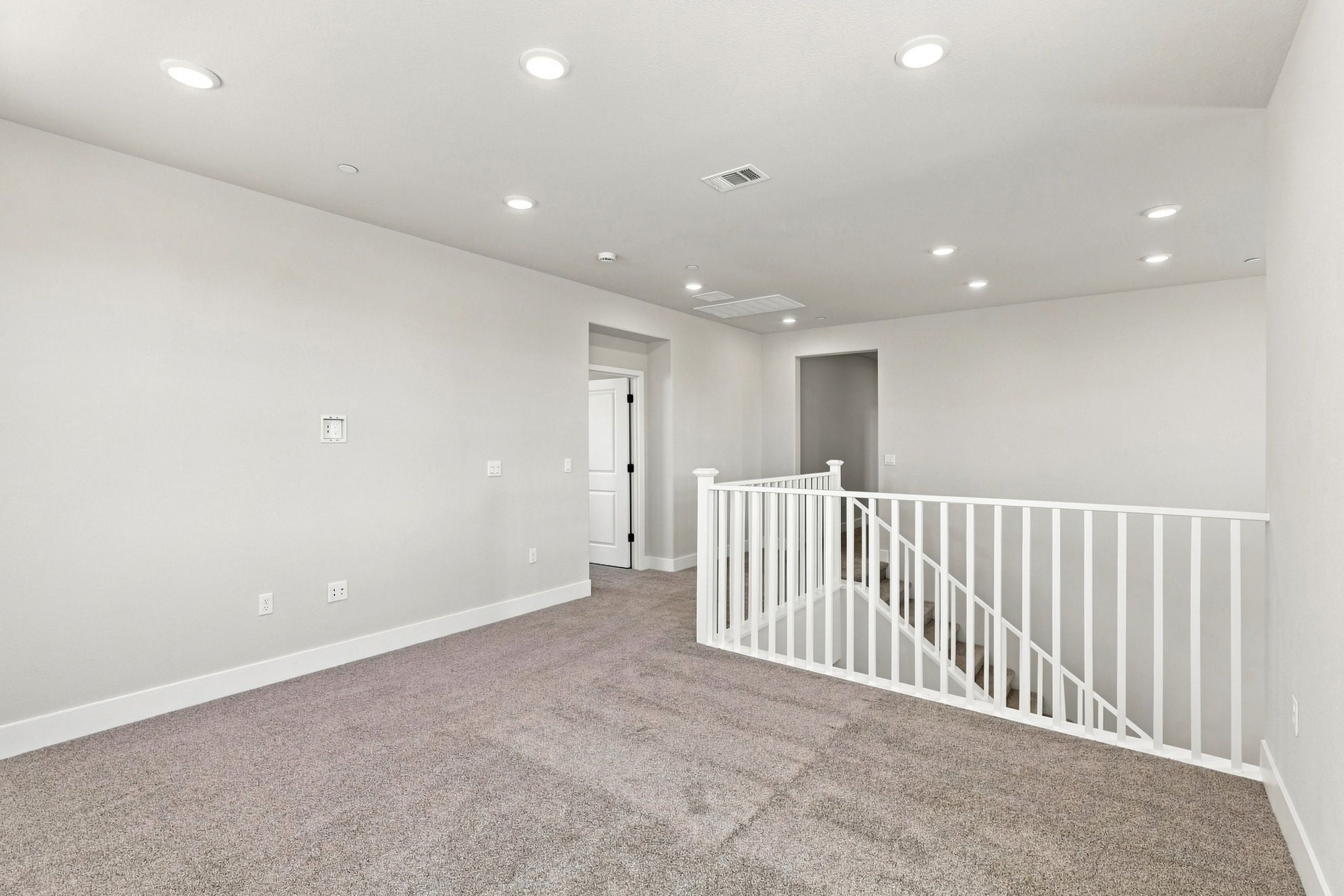 A white room with a railing.