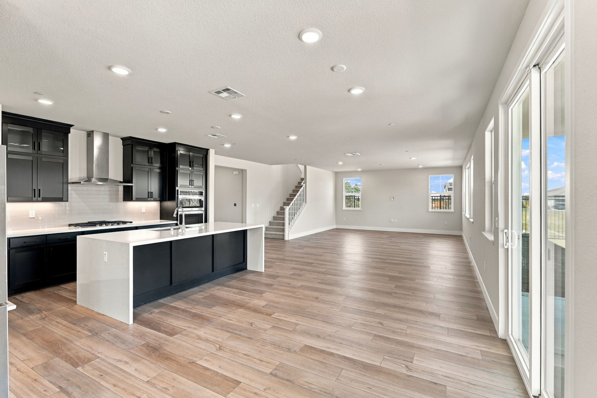 A large kitchen with black cabinets.