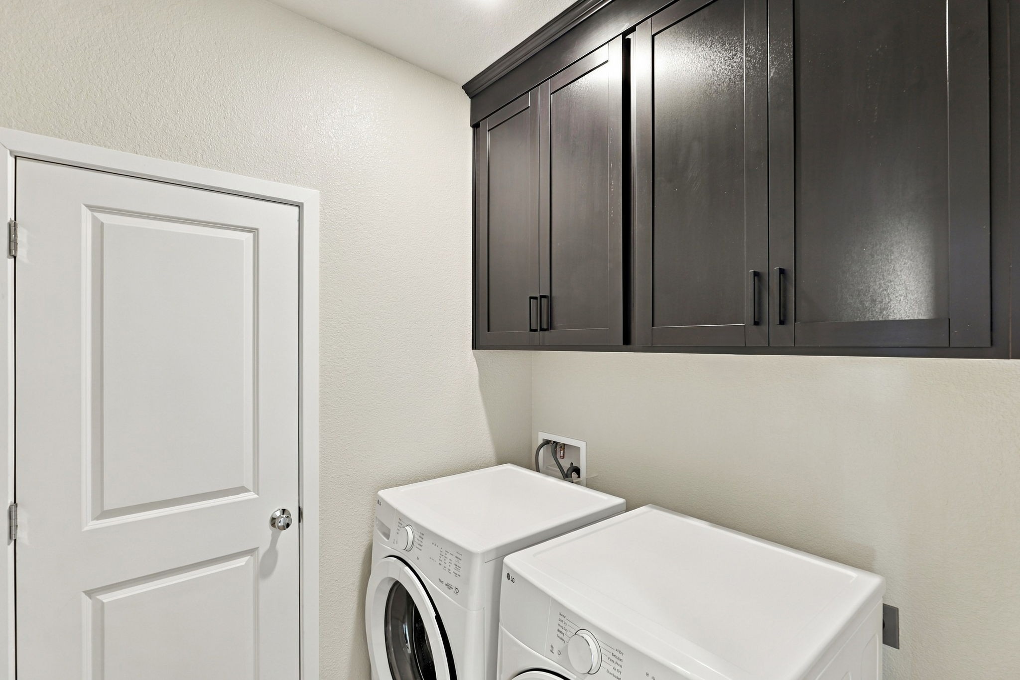 A laundry room with a washer and dryer.