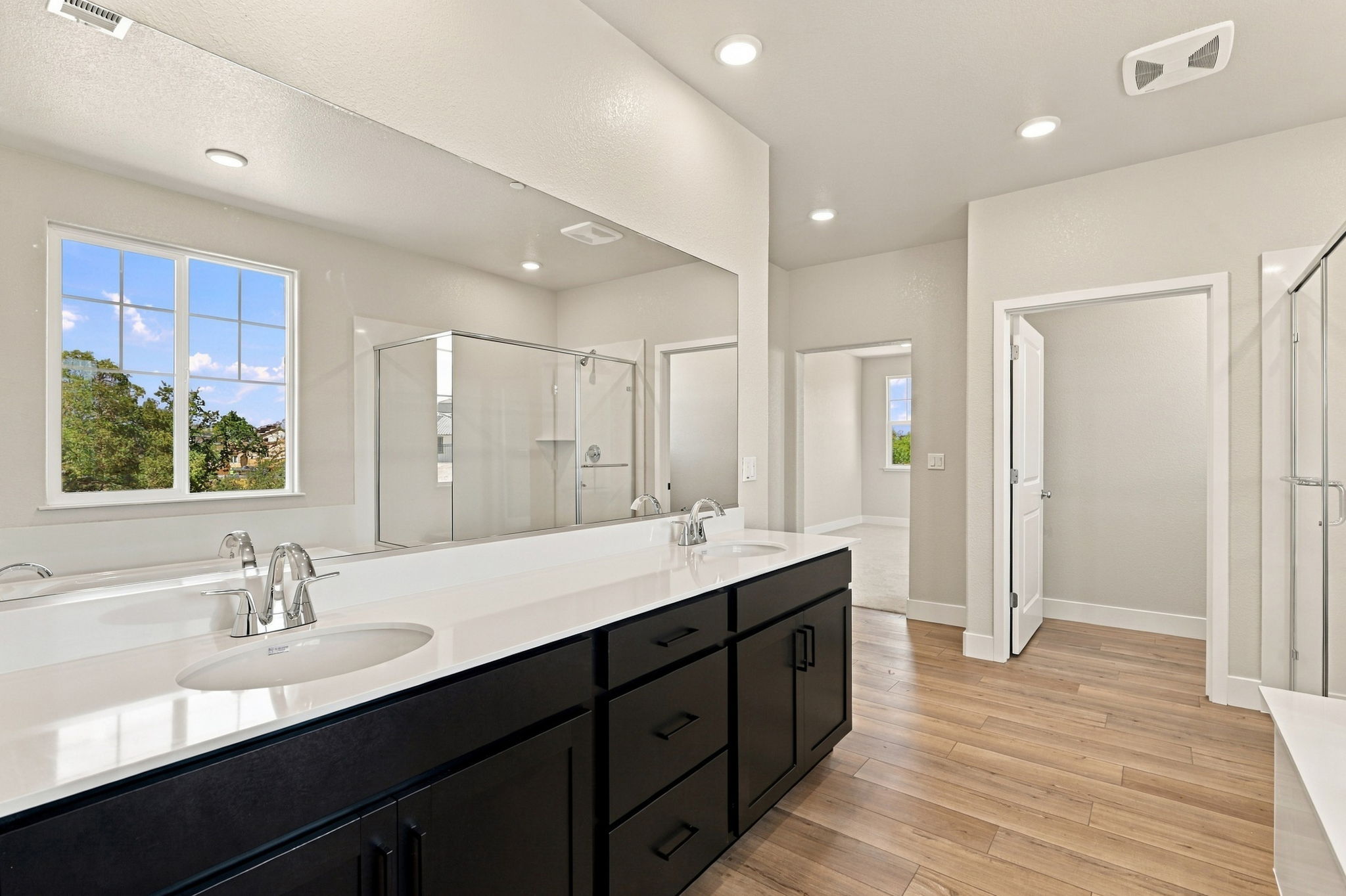 A bathroom with a large mirror.