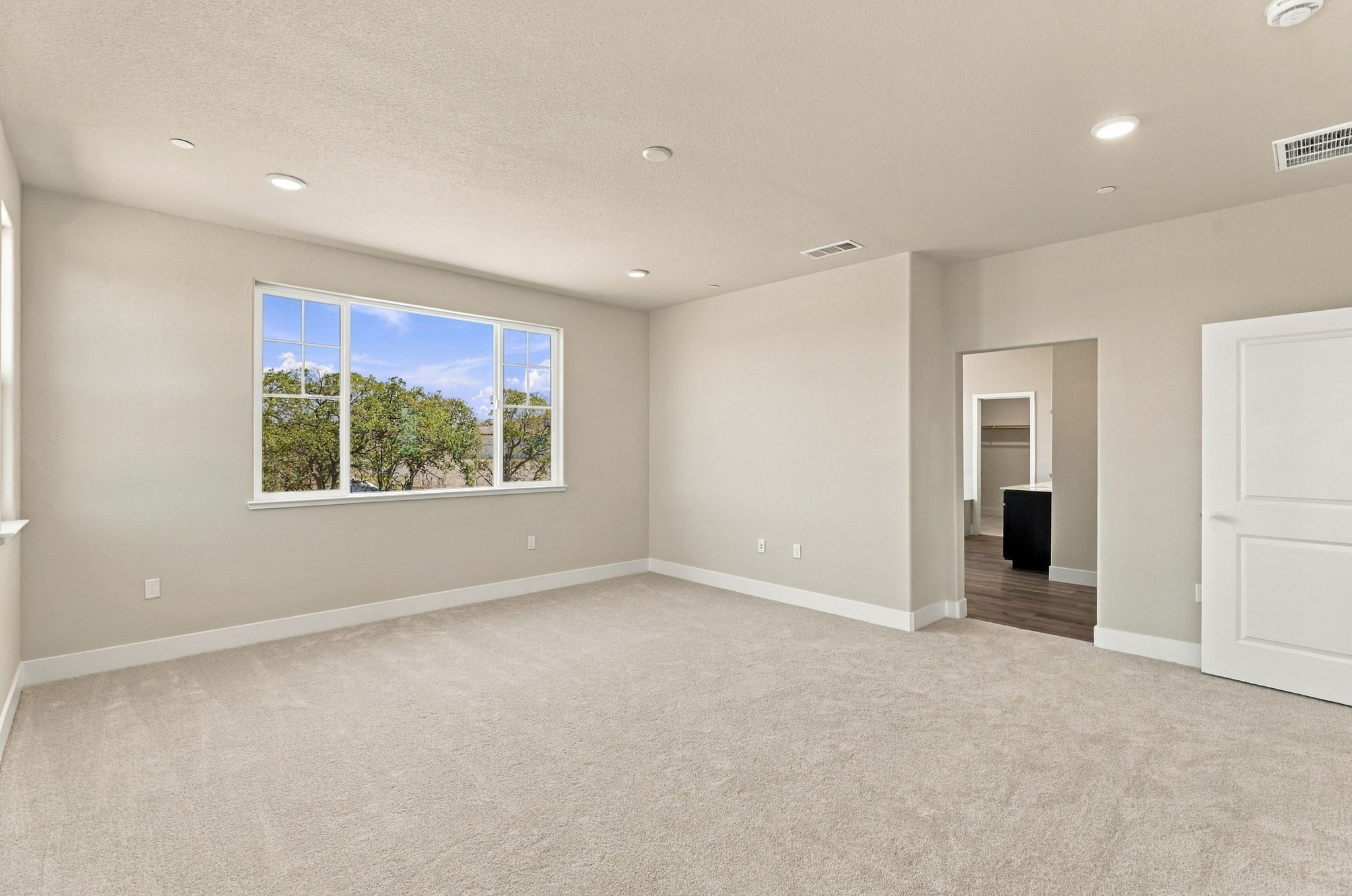 A large empty room with a large window.