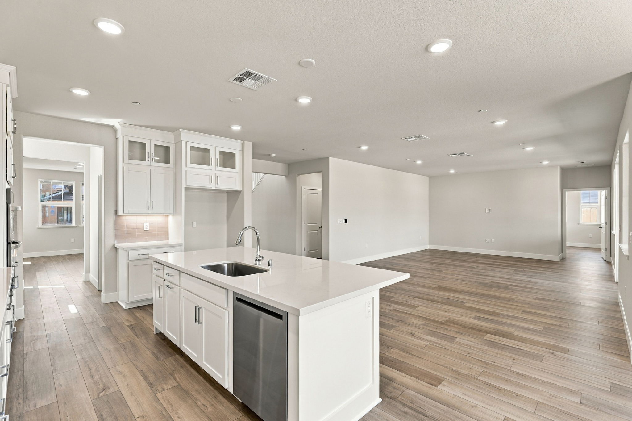 A kitchen with white cabinets.
