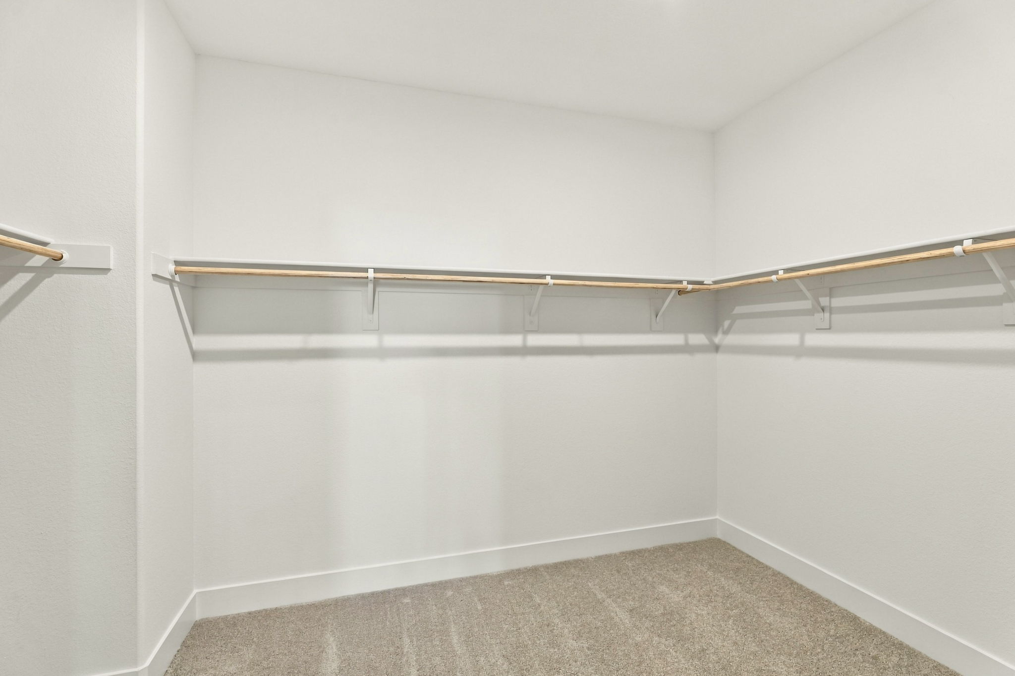 A white wall with a metal bar.