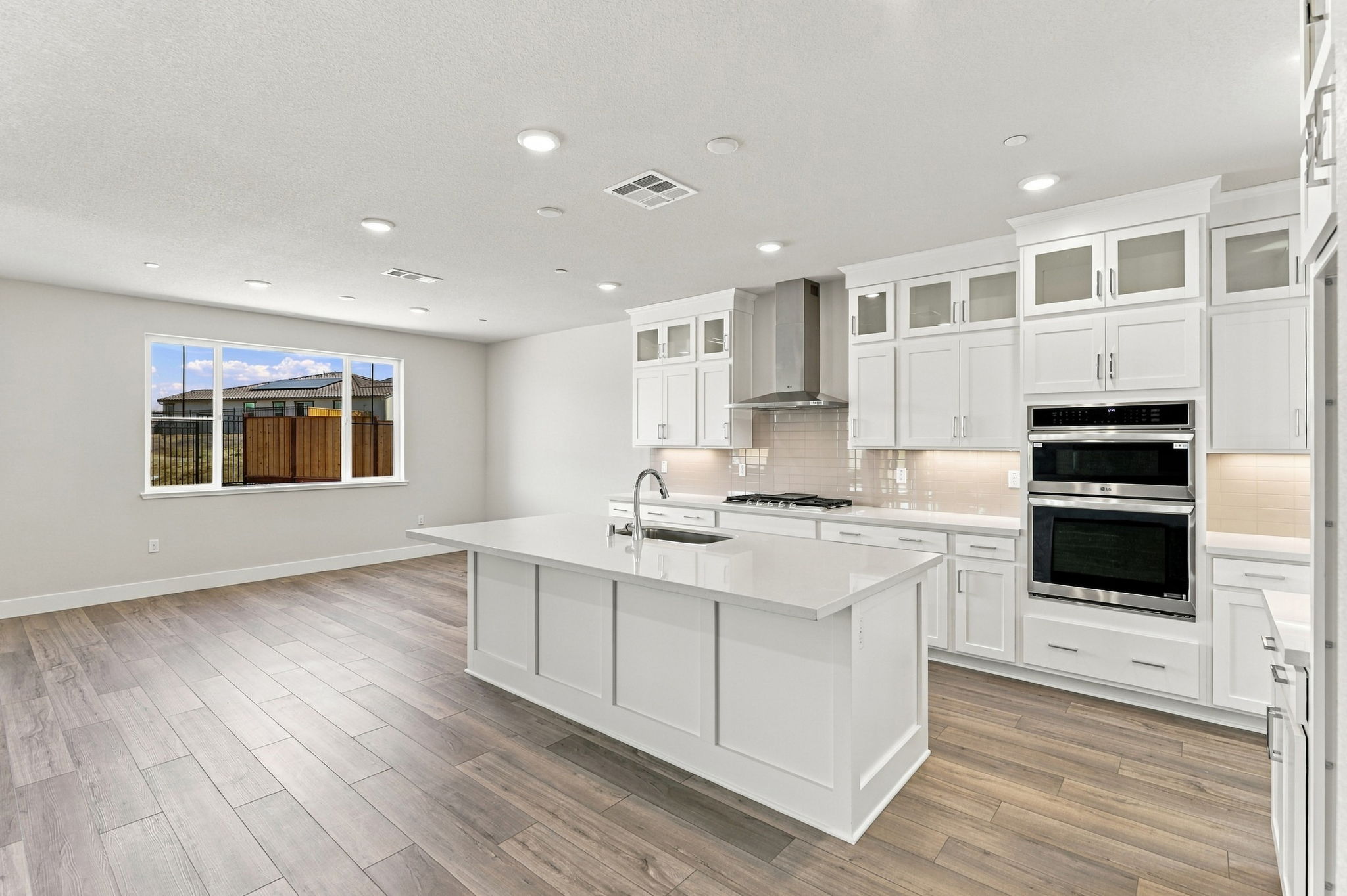 A kitchen with white cabinets.