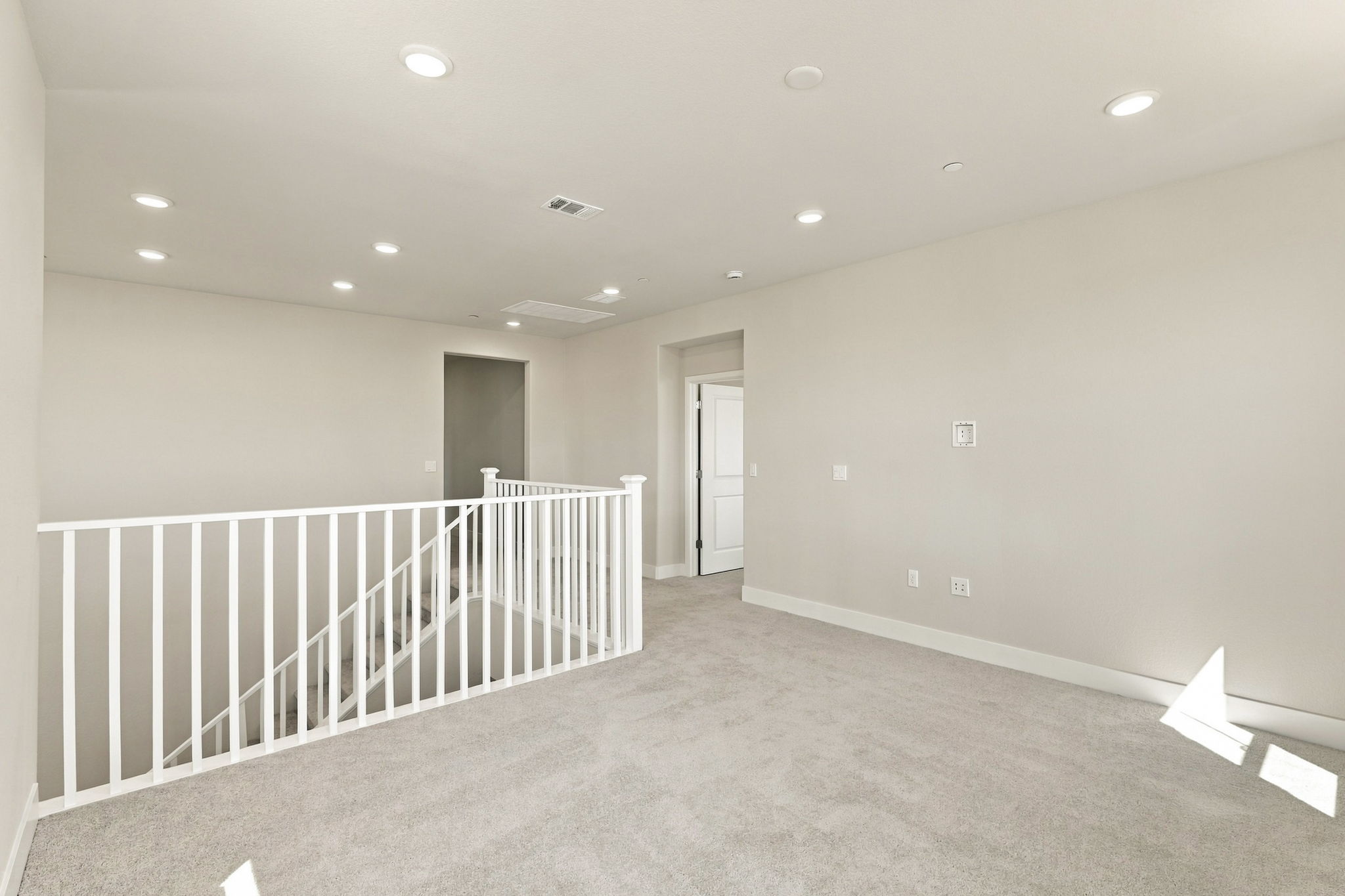 A room with a white railing and a white railing.