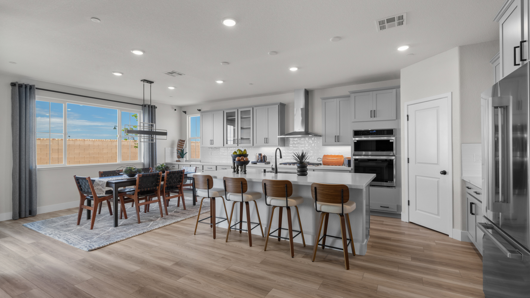 A kitchen with a dining table and chairs.