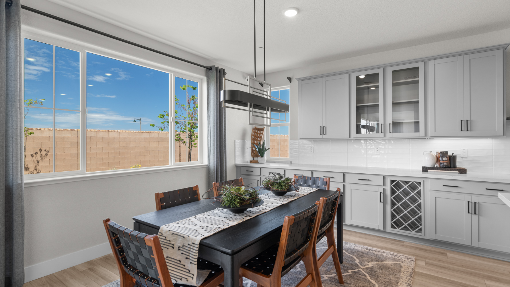 A kitchen with a table and chairs.