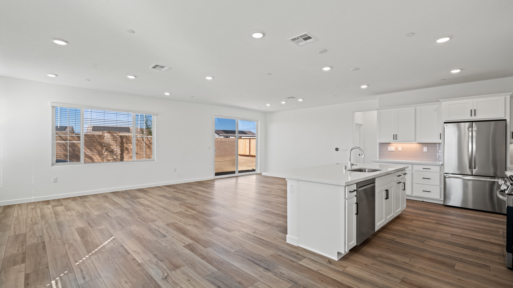 A kitchen with white cabinets.