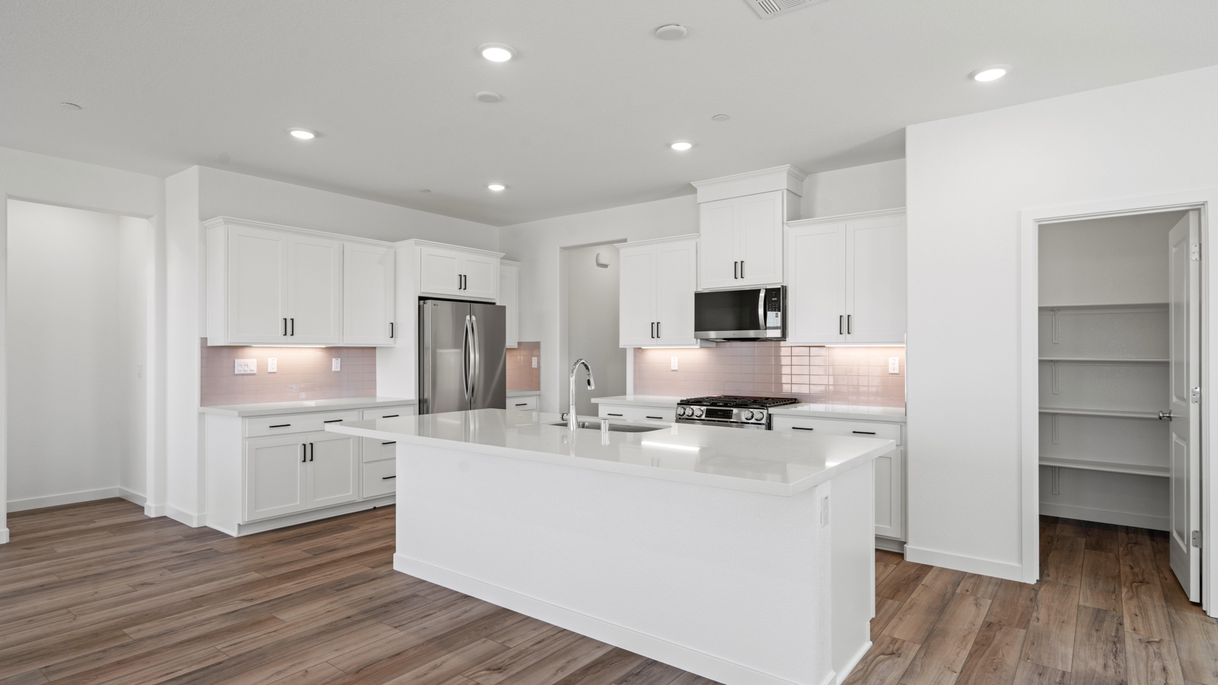 A kitchen with white cabinets.