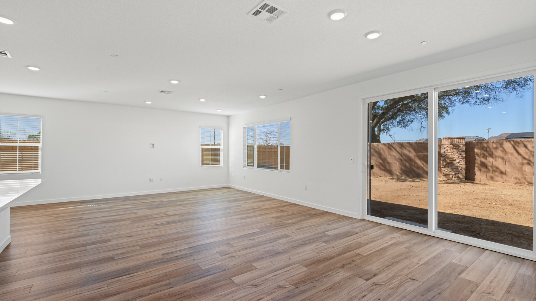 A room with a wood floor and windows.