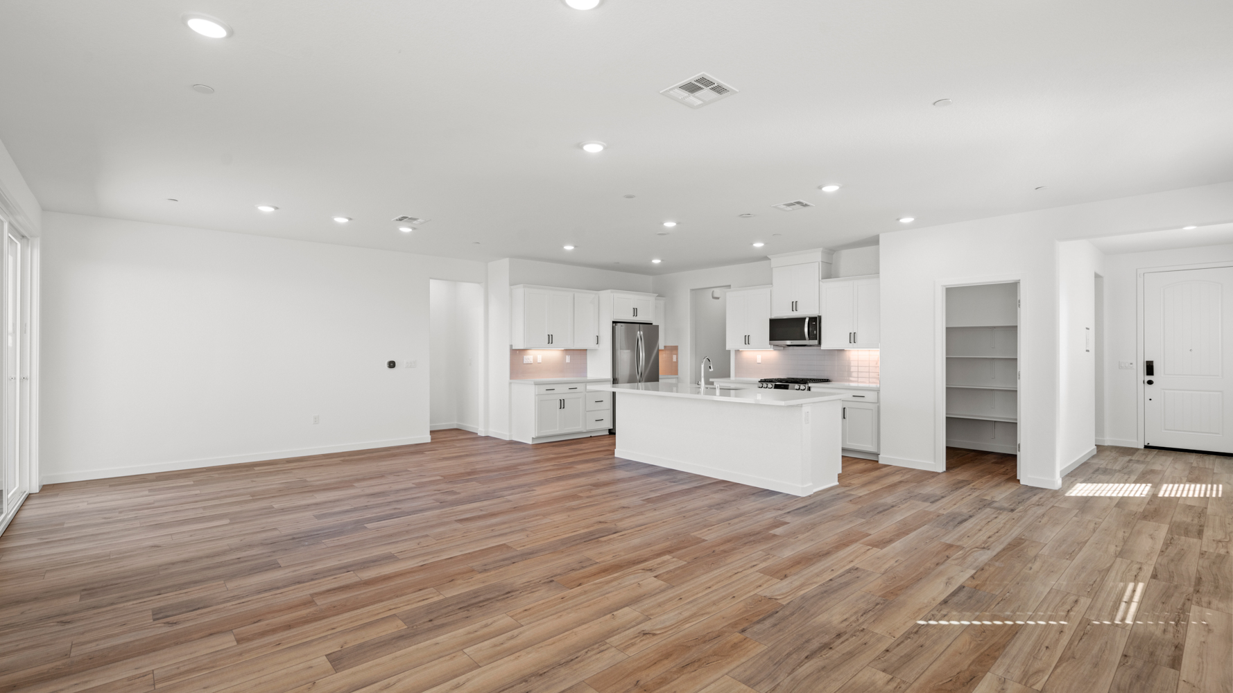 A large kitchen with white cabinets.