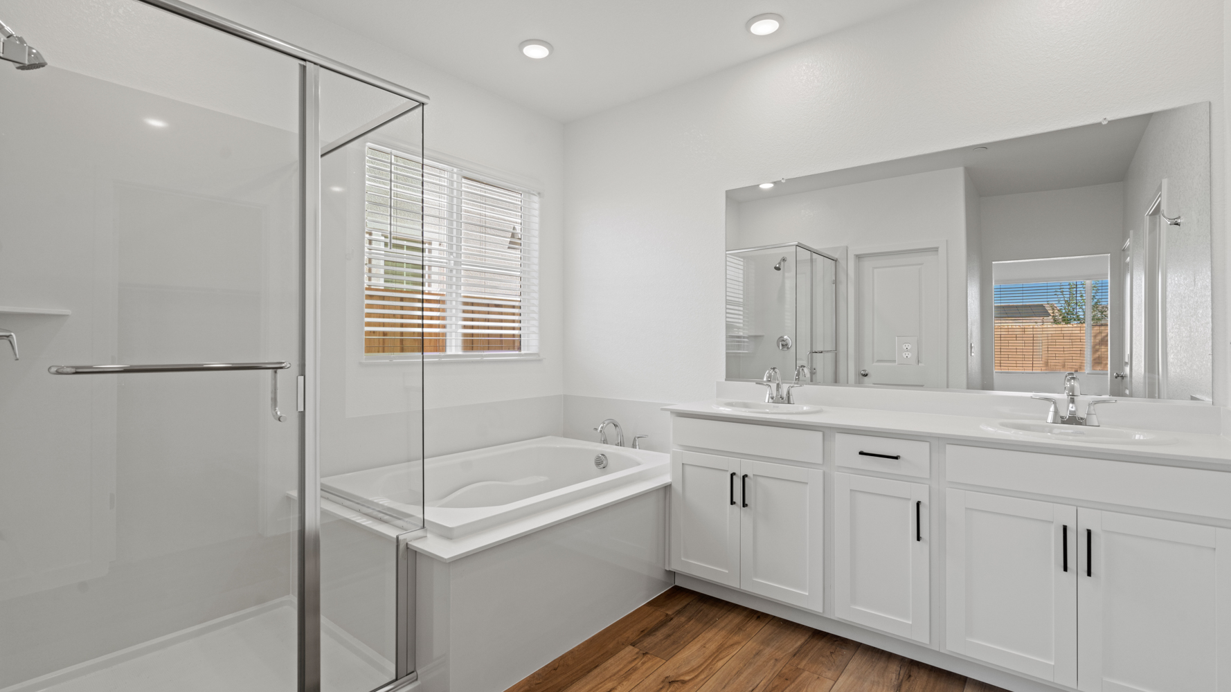 A bathroom with a tub sink and shower.