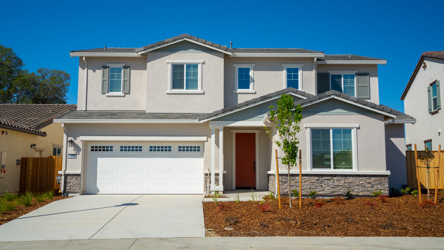A white house with a garage.