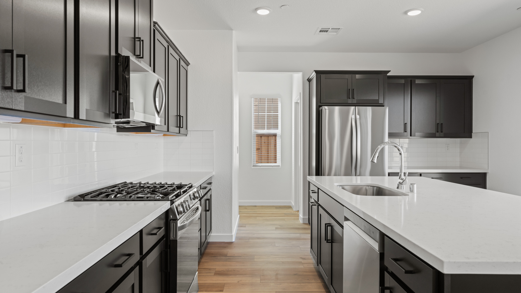 A kitchen with black cabinets.