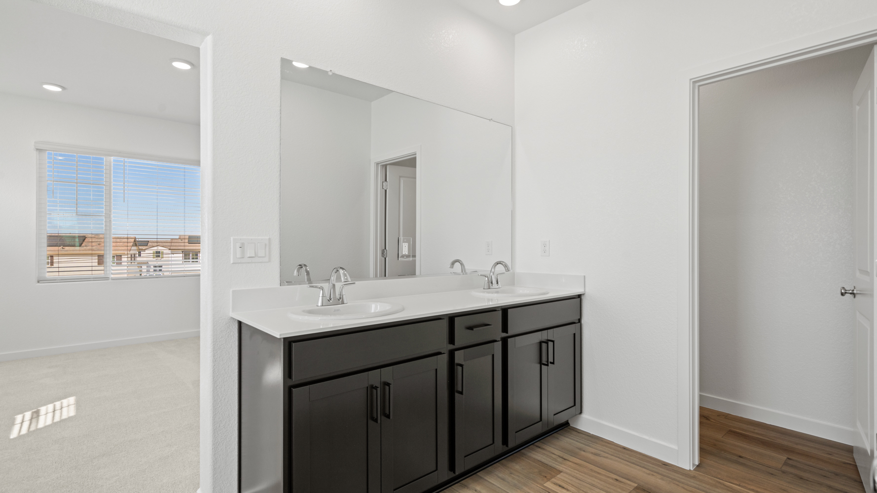 A bathroom with a large mirror.