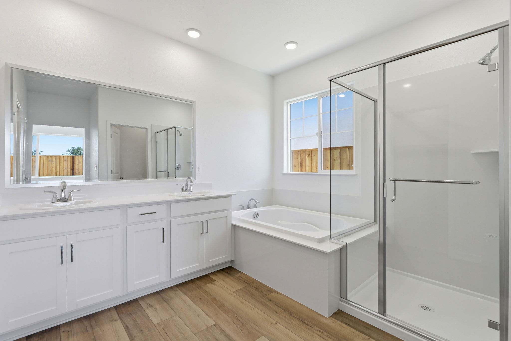A bathroom with a tub sink and a shower.