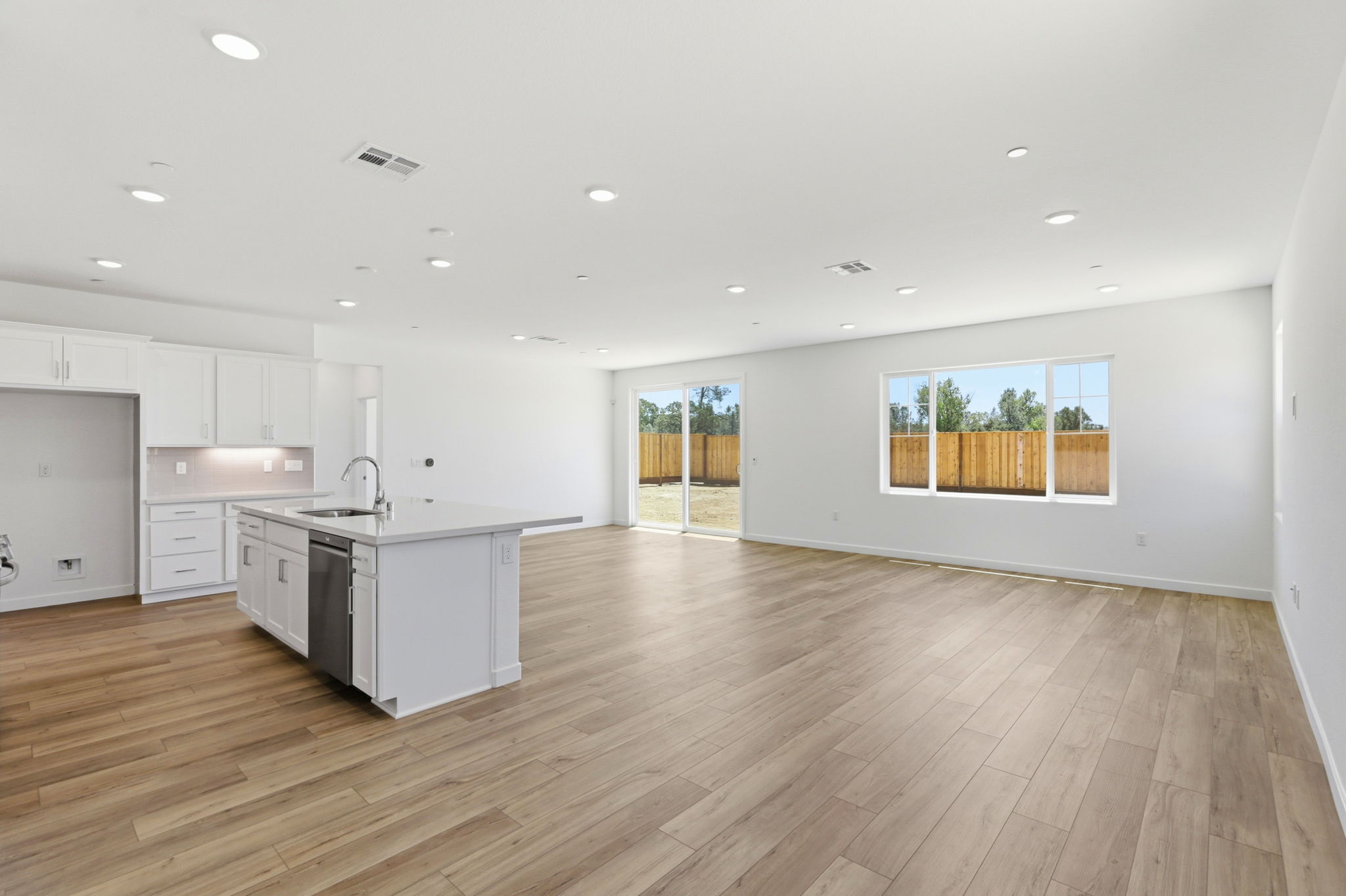 A large kitchen with white cabinets.