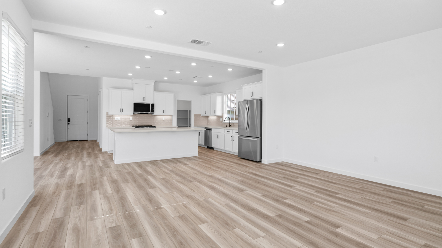 A kitchen with white cabinets.