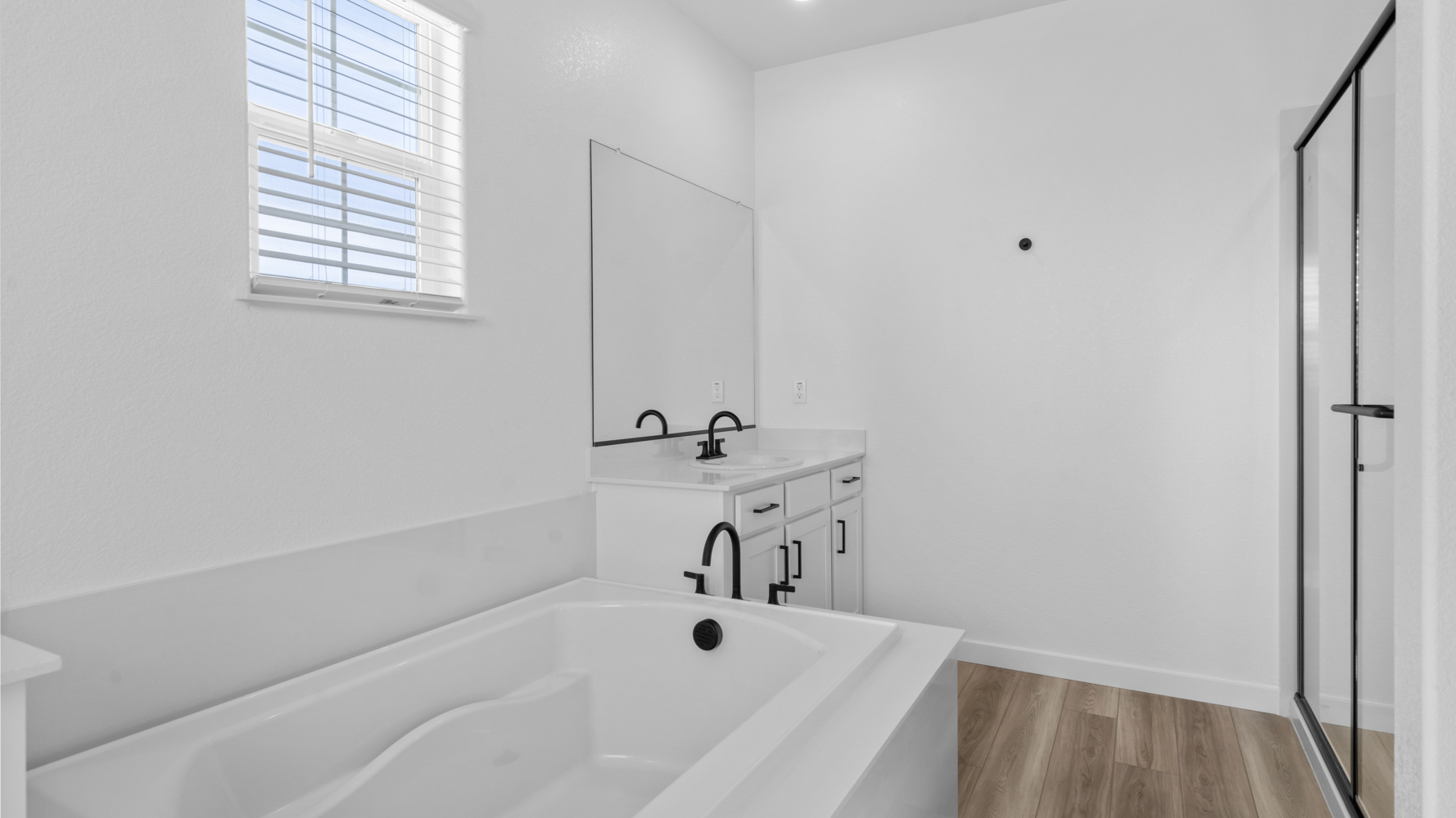 A bathroom with a tub and sink.