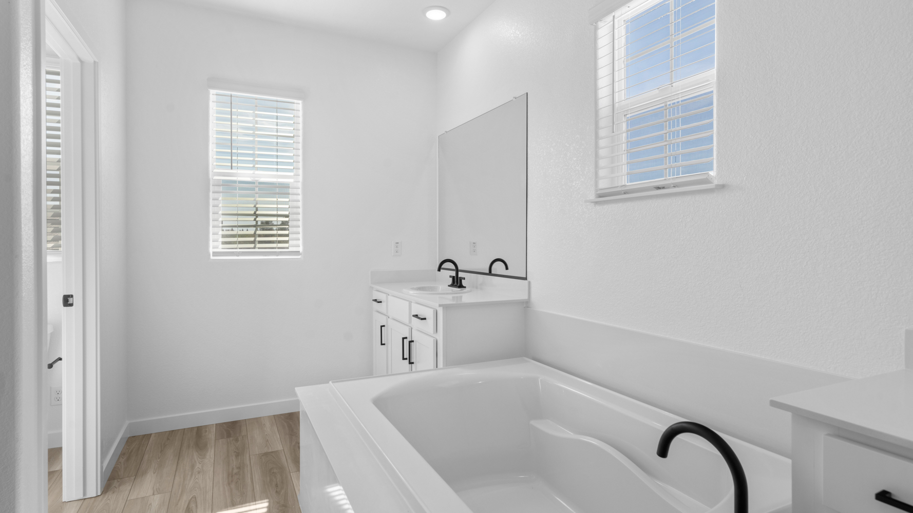 A bathroom with a tub and sink.