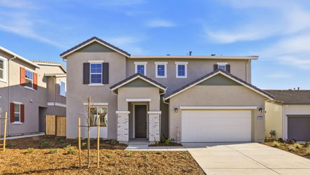 A house with garages and a sidewalk.