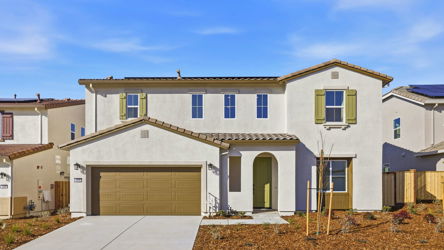 A white house with a garage.