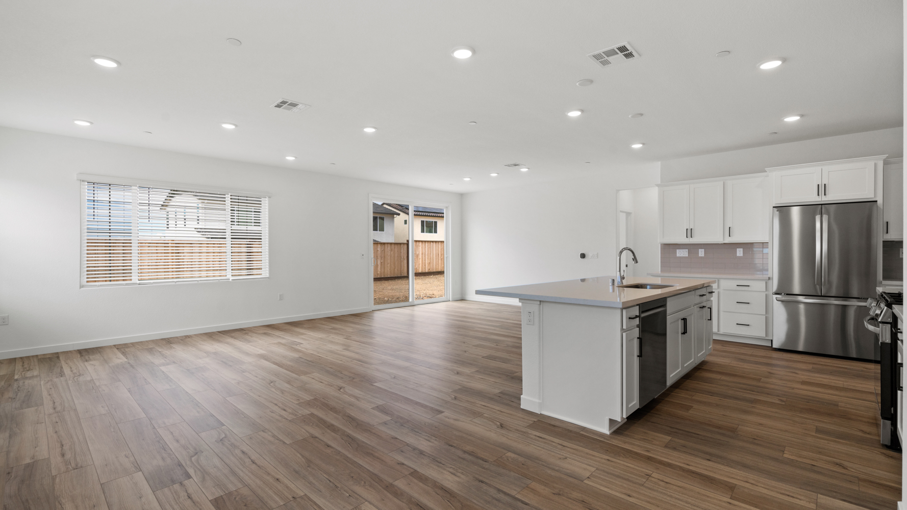 A kitchen with white cabinets.