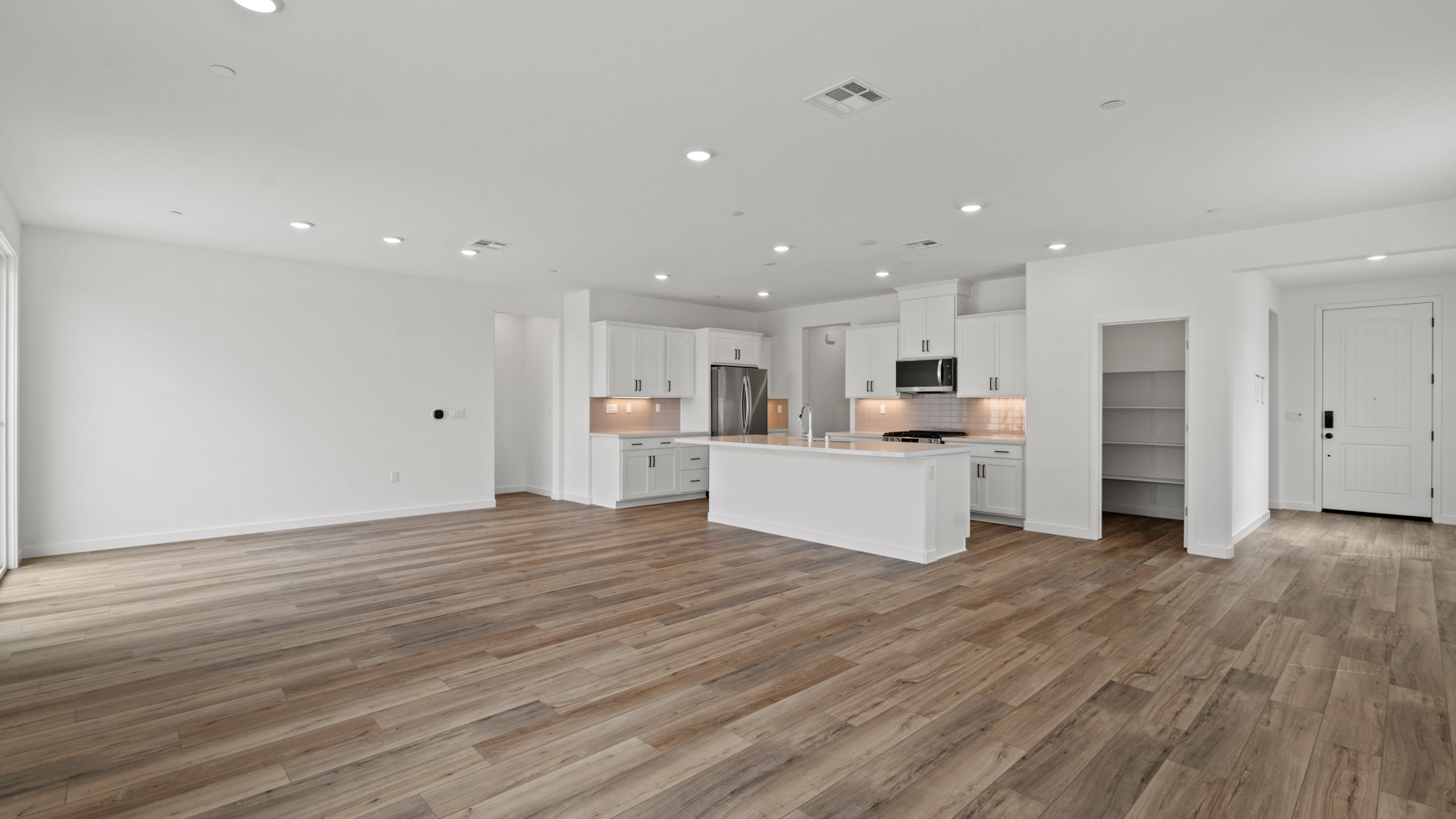 A large kitchen with white cabinets.