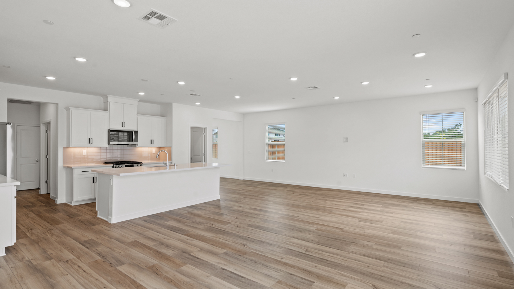 A large kitchen with white cabinets.