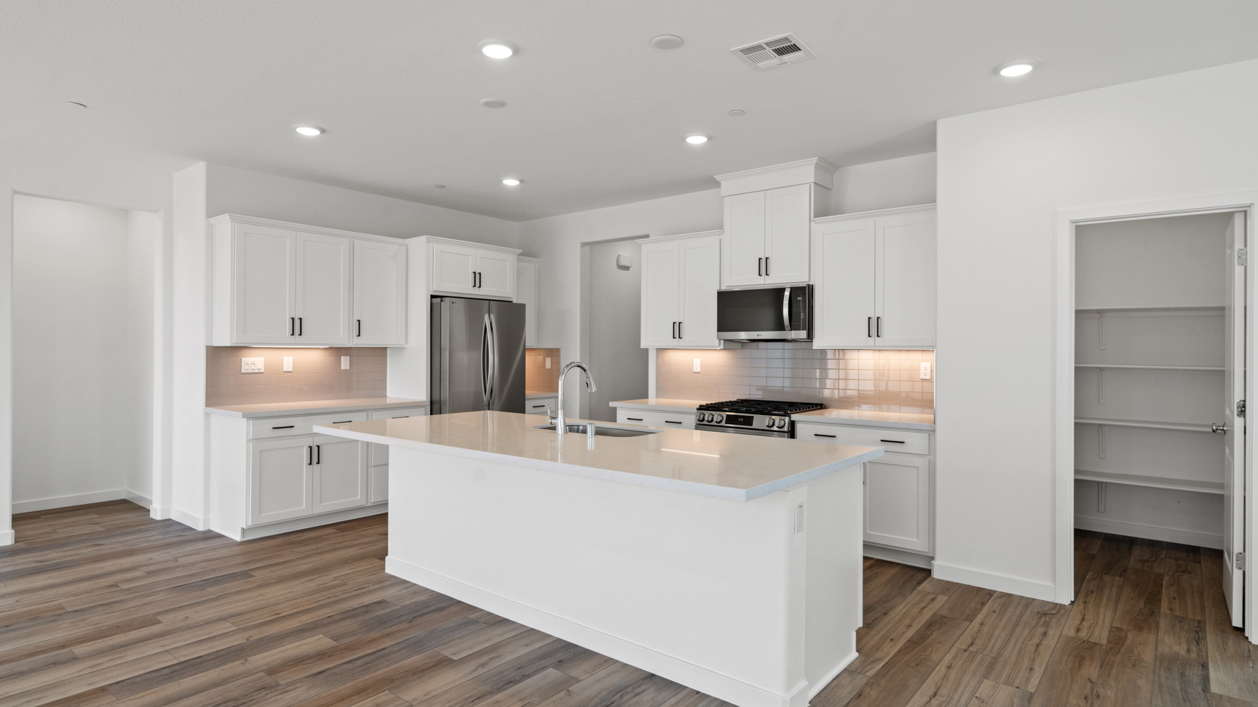 A kitchen with white cabinets.