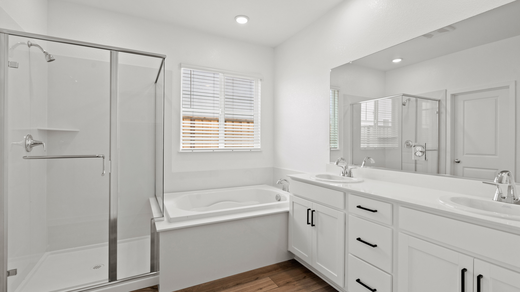 A bathroom with a tub sink and shower.